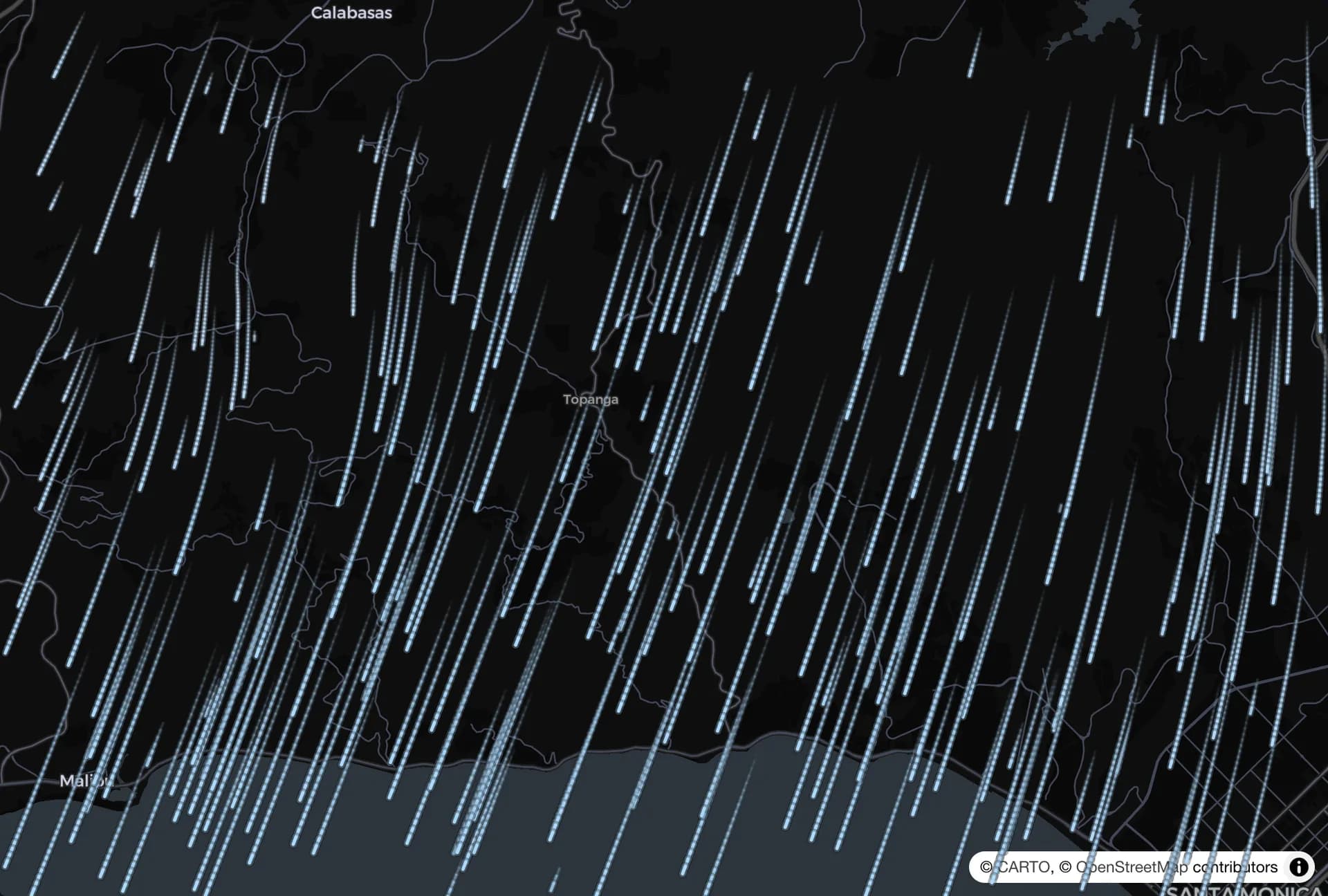 Wind streaks sweeping across the mountains toward the coast during a Santa Ana night