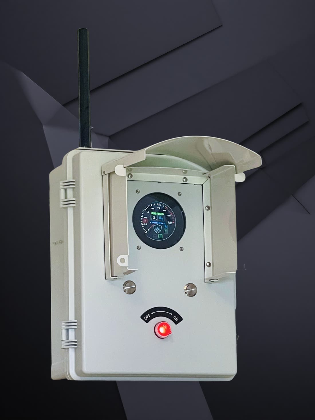 The FireShield controller: a weatherproof enclosure with an antenna, a hooded status screen, two round buttons below it and a red OFF/ON switch at the bottom